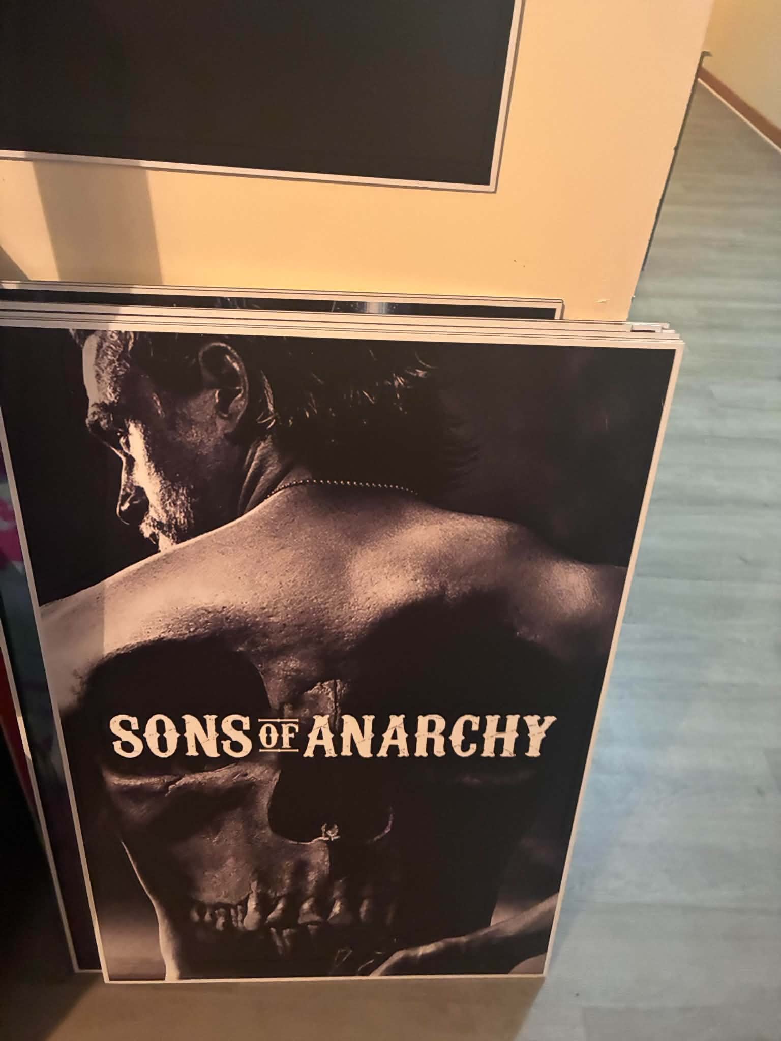 Photo of a Sons of Anarchy poster print with Jax Teller in stark profile over a giant grim reaper skull