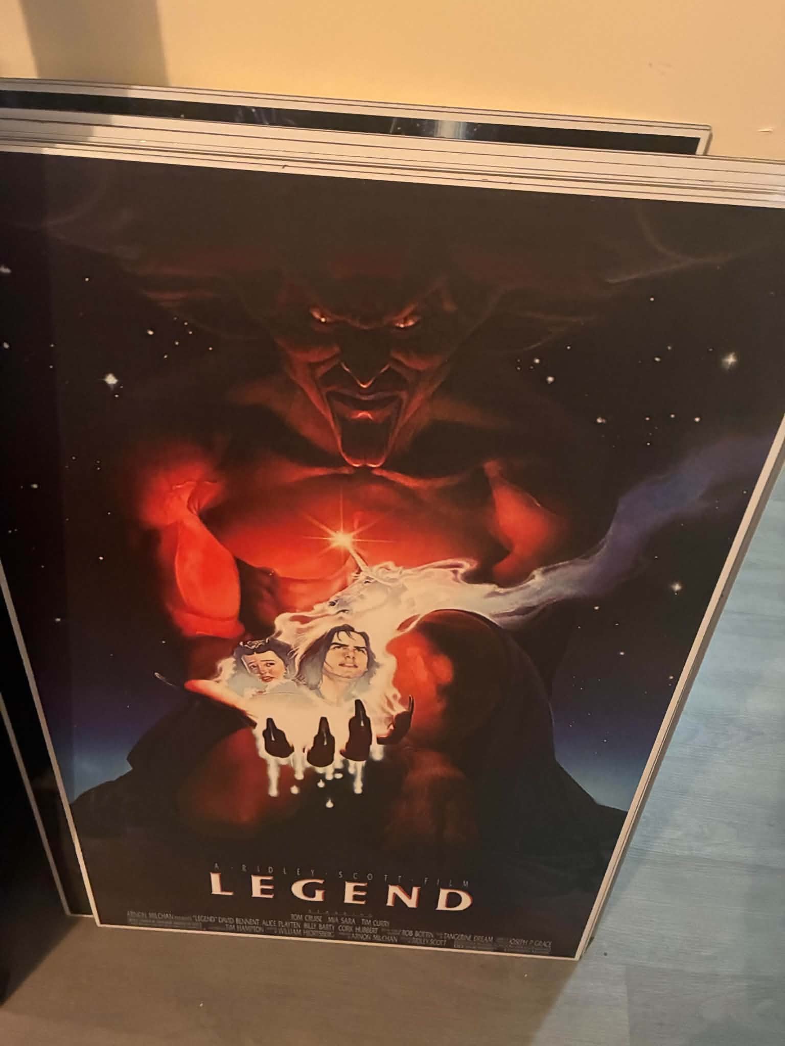 Photo of a Legend movie poster print with the horned demon Darkness looming over unicorns and tiny heroes