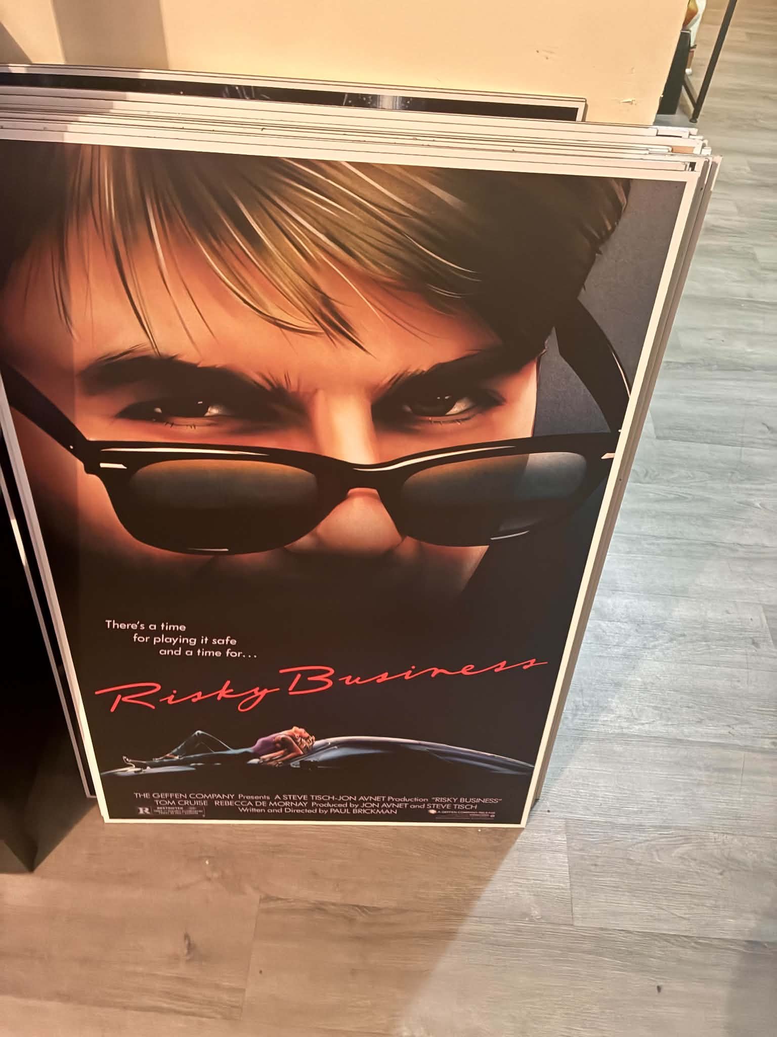 Photo of a Risky Business poster print of Tom Cruise in sunglasses under the tagline about a time for playing it safe